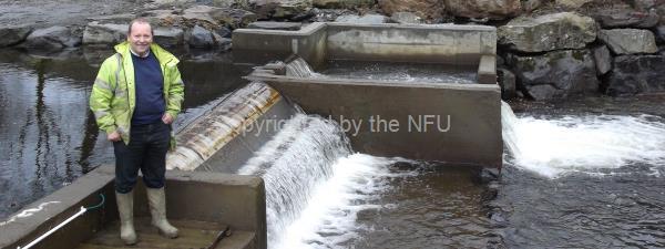 Tegwyn Jones with his hydropower installation on his farm at the edge of Snowdonia Natonal Park.