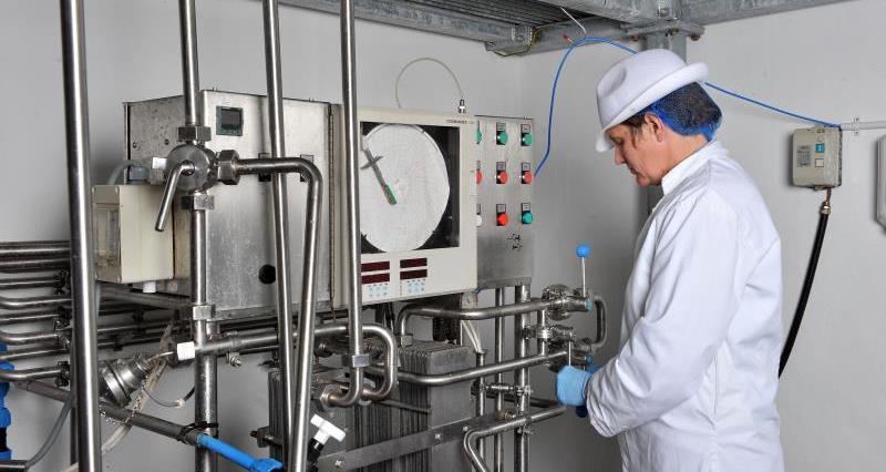 An image of a food scientist operating a machine in a lab