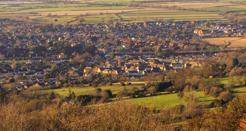 A picture of lots of houses and residential buildings in villages and a town, surrounded by the countryside.