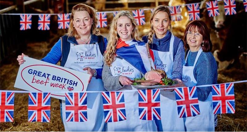 A group of ladies in a barn with Great British Beef Week branding
