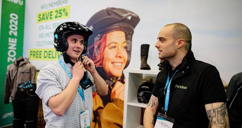 Harry Madin trying on Spada helmet stand at NFU conference 2020_72376