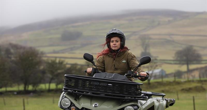 Hannah Jackson holding an ATV helment