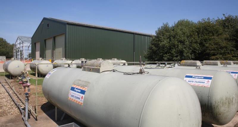 An image of gas tanks in an agricultural setting.
