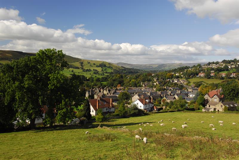 A village in the Peak District with sheep grazing in the foreground