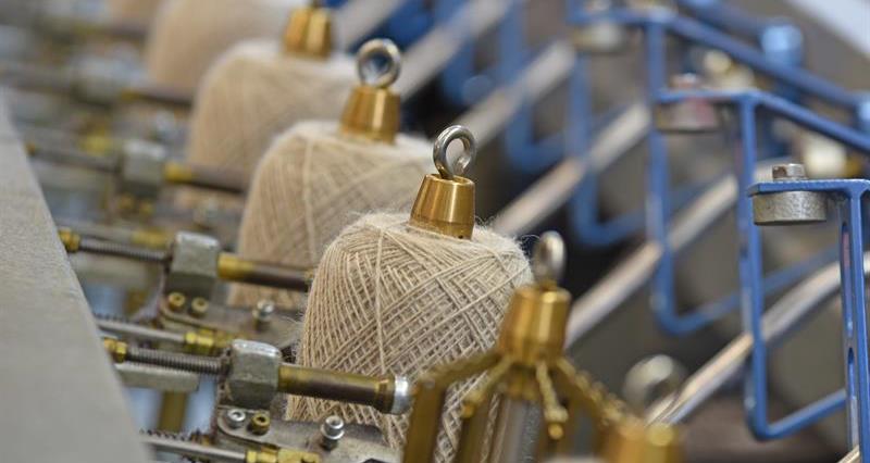 A photo of wool being produced at a wool making factory. 