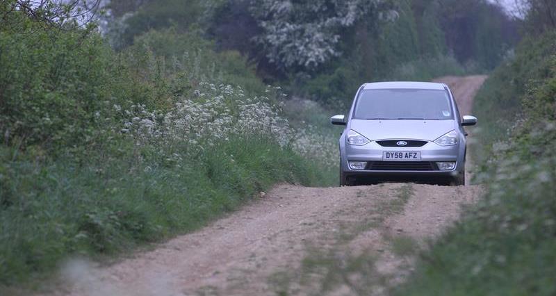 Car driving on country lane_64048