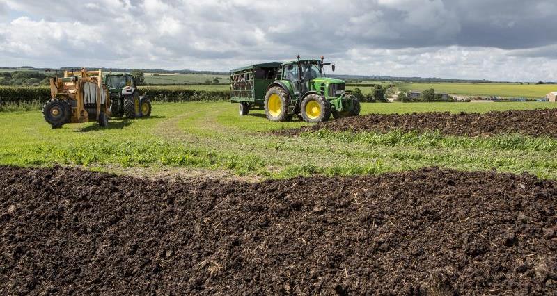 Tractors driving across organic farm