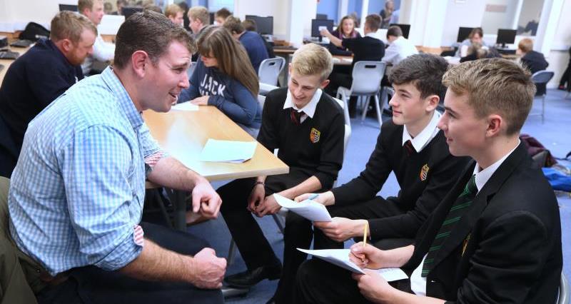An image of secondary school students asking a farmer questions at a careers event in Teesdale the North East of England