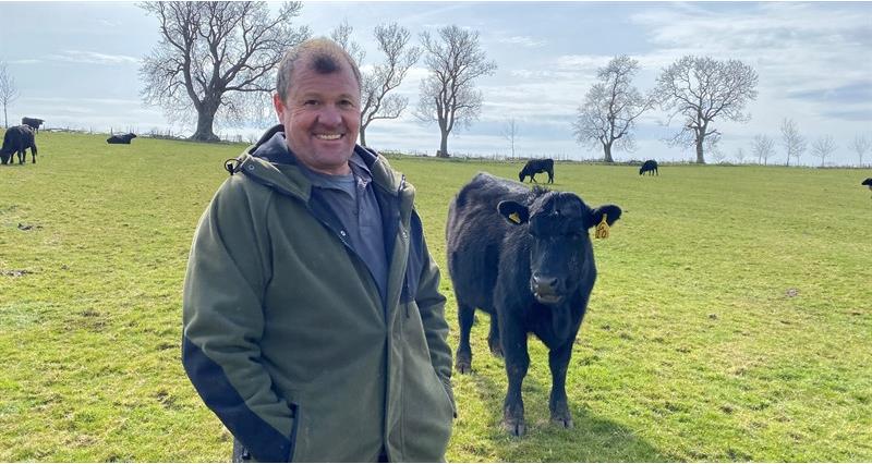Duncan Nelless on his farm with cattle in the background