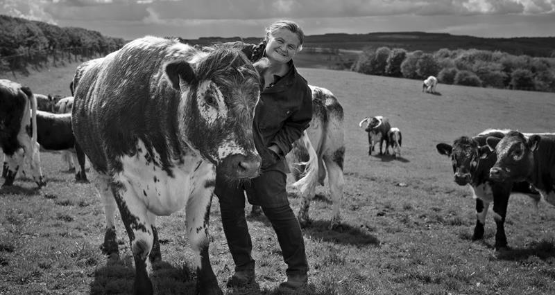 Farmer Ruth Russell in a pastoral Yorkshire landscape with her longhorn cattle
