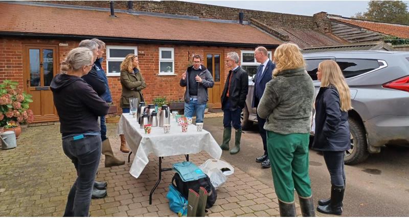 NFU members, staff and government officials gathered around a table, listening to John Torrence talk about on-farm practices