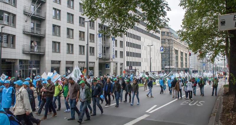 Protesters marching through a street in Brussels