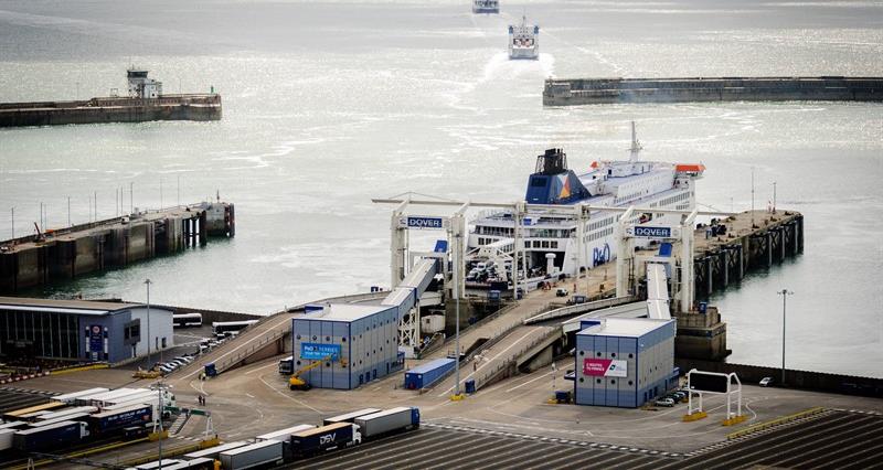 A photo of cargo lorries waiting to board a boat at the port of dover.