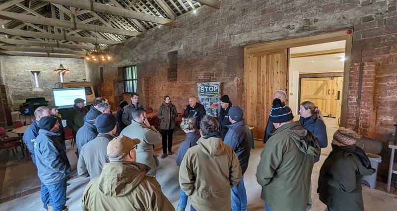 A group of people standing in a barn