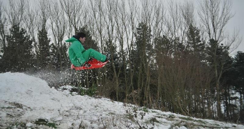 An intrepid sledger flies off a ramp on a farm in Worcestershire during snowy weather