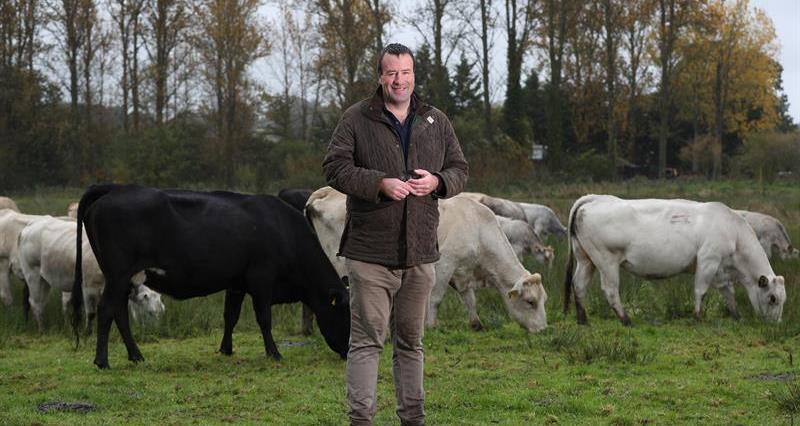 Stuart Roberts stood in front of cows
