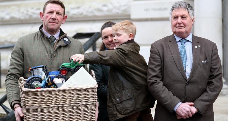 Basket of pre-loved farm toys handed over by Hazel and Tom Church, their 5-year-old son Bertie, together with Hazel’s father 66-year-old Martin Towler