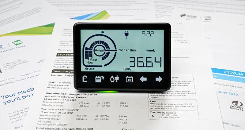 An energy meter on stacks of bills