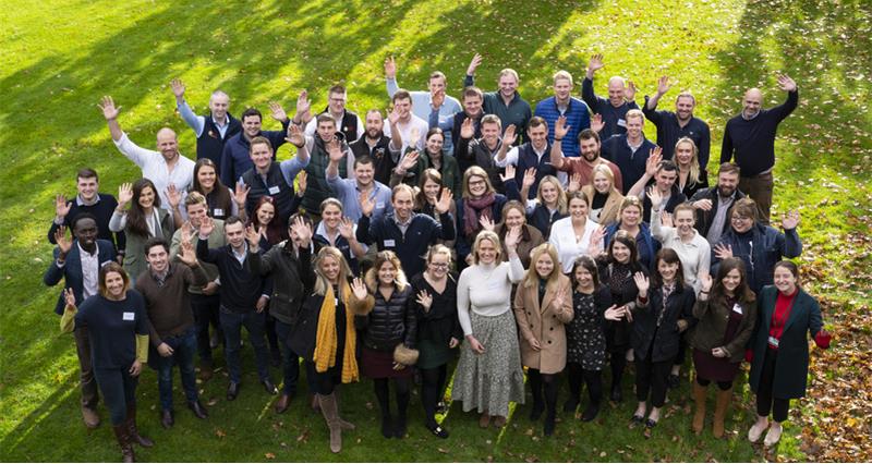 A group photo of the UK Farming Unions Next Generation Groups waving in a park