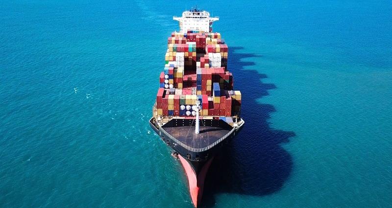 A boat carrying shipping containers across the sea
