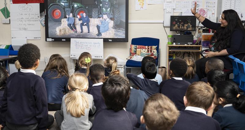 An image of Science Farm Live 2023! lessons at a primary school in Coventry, Warwickshire. The image shows schoolchildren watching the live lesson on a large screen.