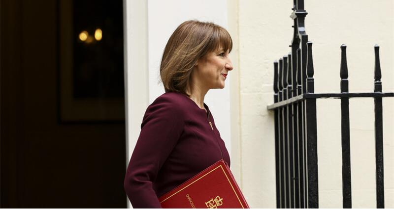 Rachel Reeves walking outside Number 11 holding her red book