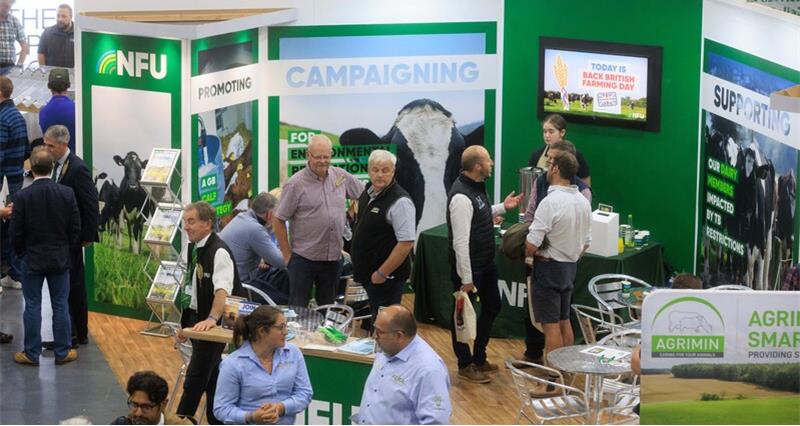 A picture of members talking to NFU advisers on a busy NFU stand at UK Dairy Day 2025