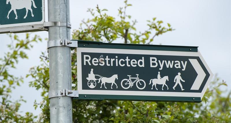 A restricted byway path sign