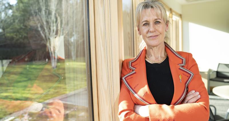An image of Minette Batters, leaning against an office window