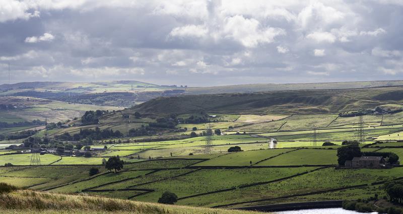 Landscaoe of rolling hills with some electricity pylons 