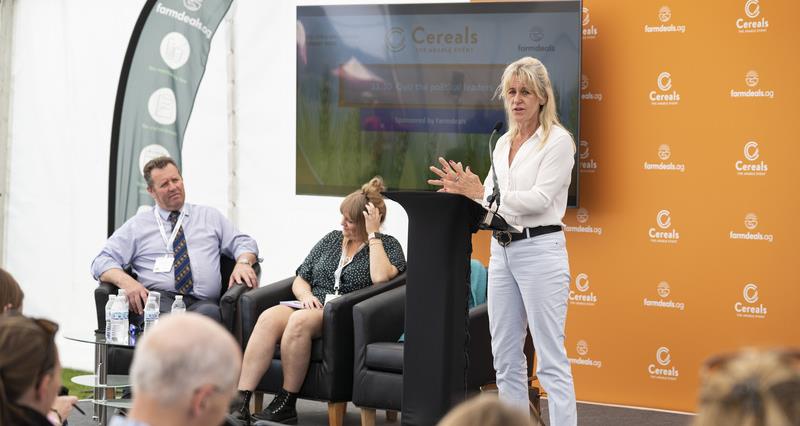 An image of NFU Minette Batters stood in a stage with the Farming Minister and Abi Kay