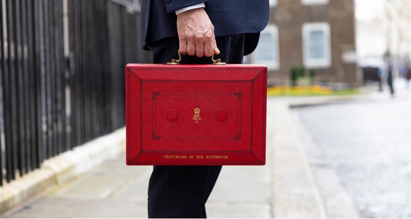 Close up of a red briefcase and a hand