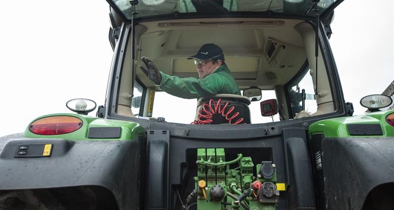 A farmer pictured in a tractor cab