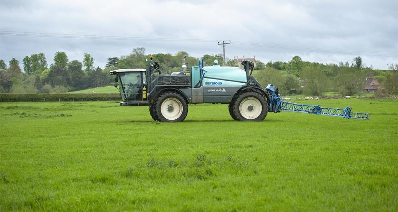 An image of a sprayer vehicle in a farm field