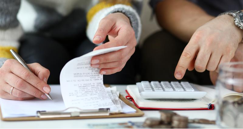 Man and woman writing up family accounts