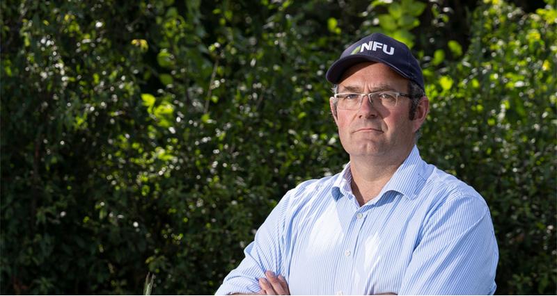 NFU Deputy President Tom Bradshaw stood in front of a hedge