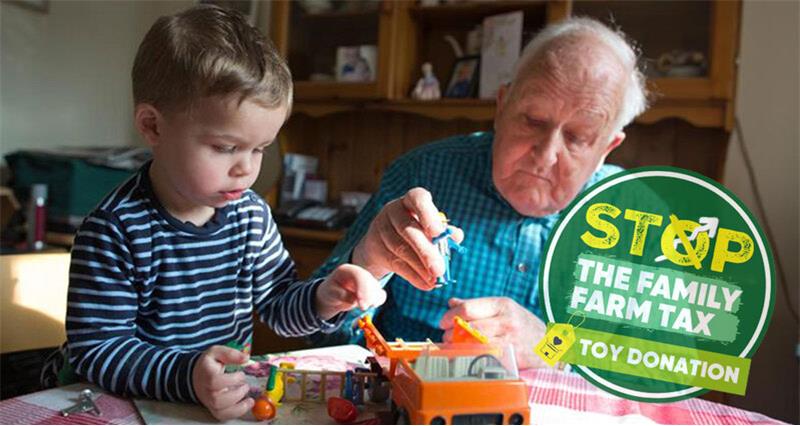 Grandfather playing with his grandson and his toy truck