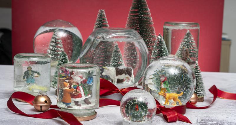 A selection of handmade snowglobes with Christmas figurines inside them