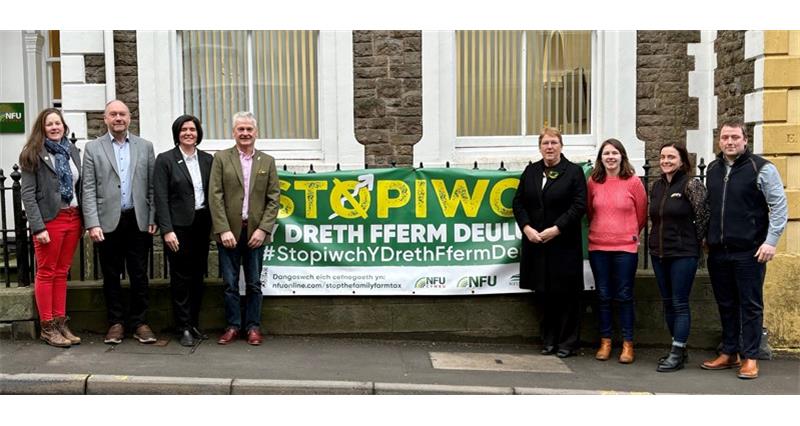 Group of people having photo in front of banner