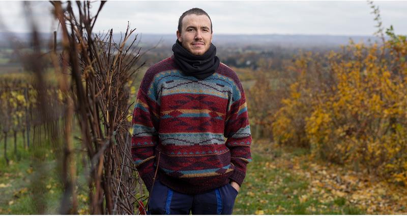 David Clay stood in a field next to a hedge