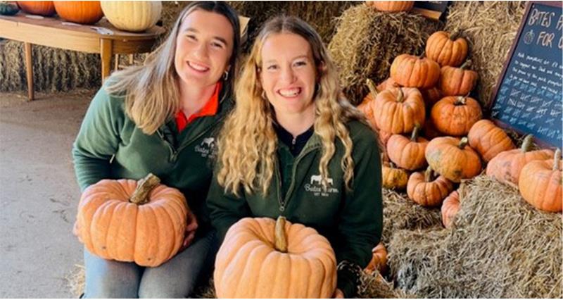 Fiona and Alison Wilshaw holding pumpkins
