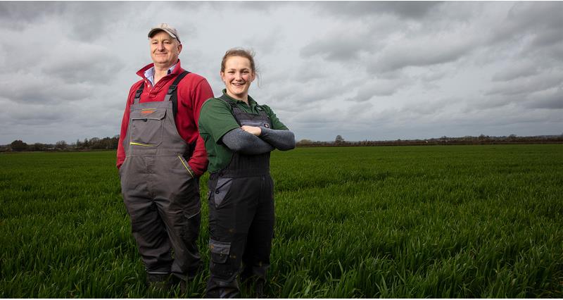 An image of Darcy and Rob Johnson stood in a field of grass