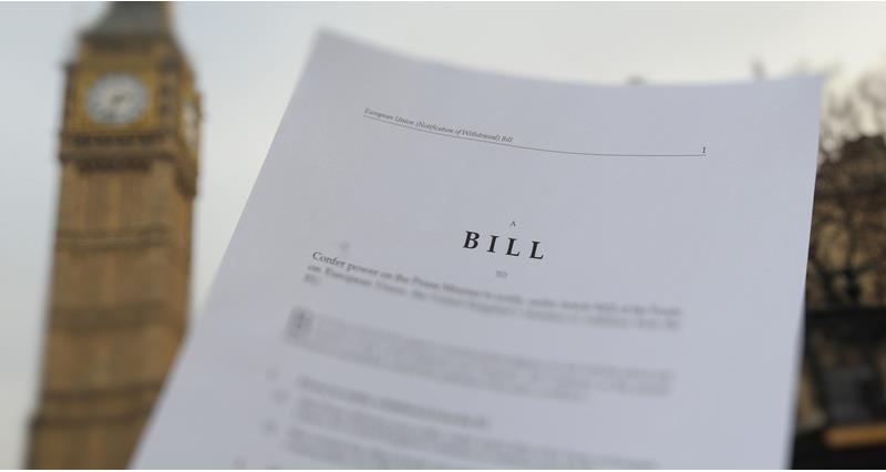 Blurred bill being held in front of Big Ben