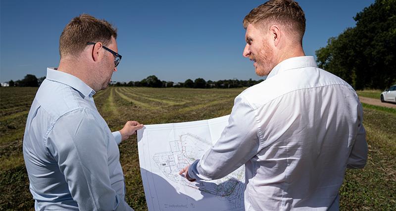 Two men looking at a planning document