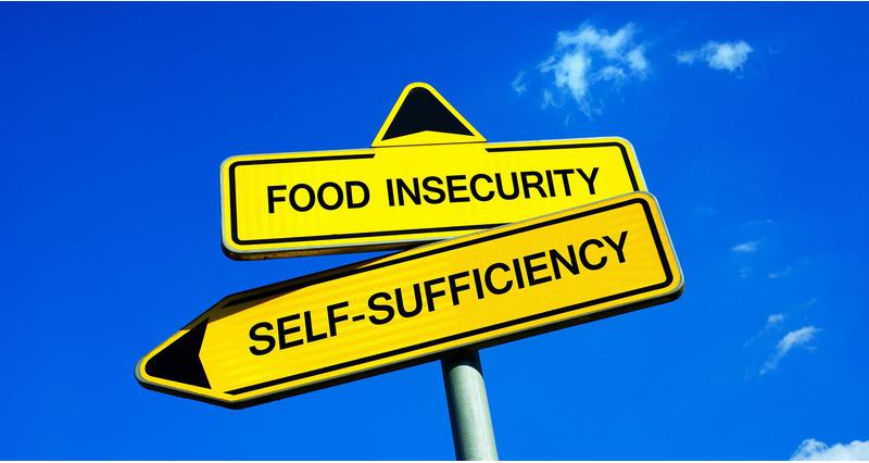 Signpost with Food insecurity pointing upwards and self sufficiency downwards