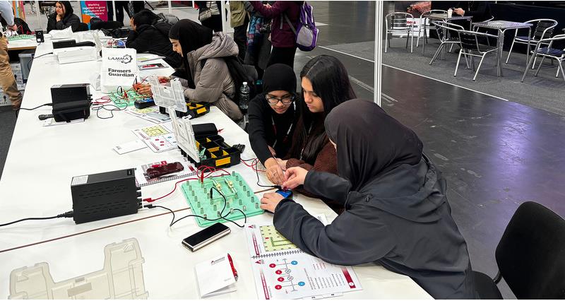 Students working together on a table at LAMMA 25 as part of an NFU Education event