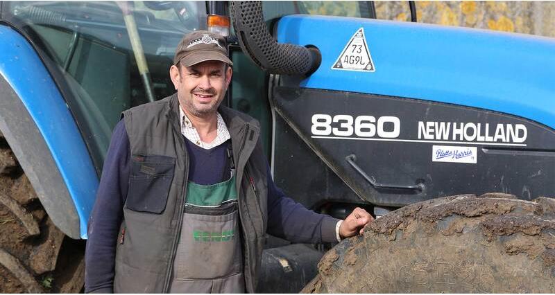 NFU member and arable farmer Angus Hamilton stood in front of a tractor