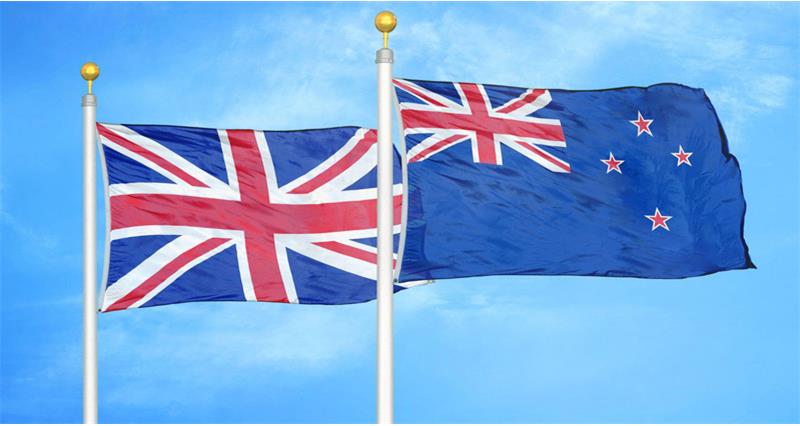 A photo of the UK and New Zealand flags on flagpoles