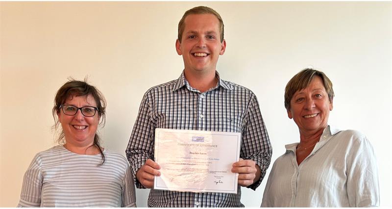 A photo of Dominic Luas holding his certificate of participation for a Vetworks workshop in Belgium.