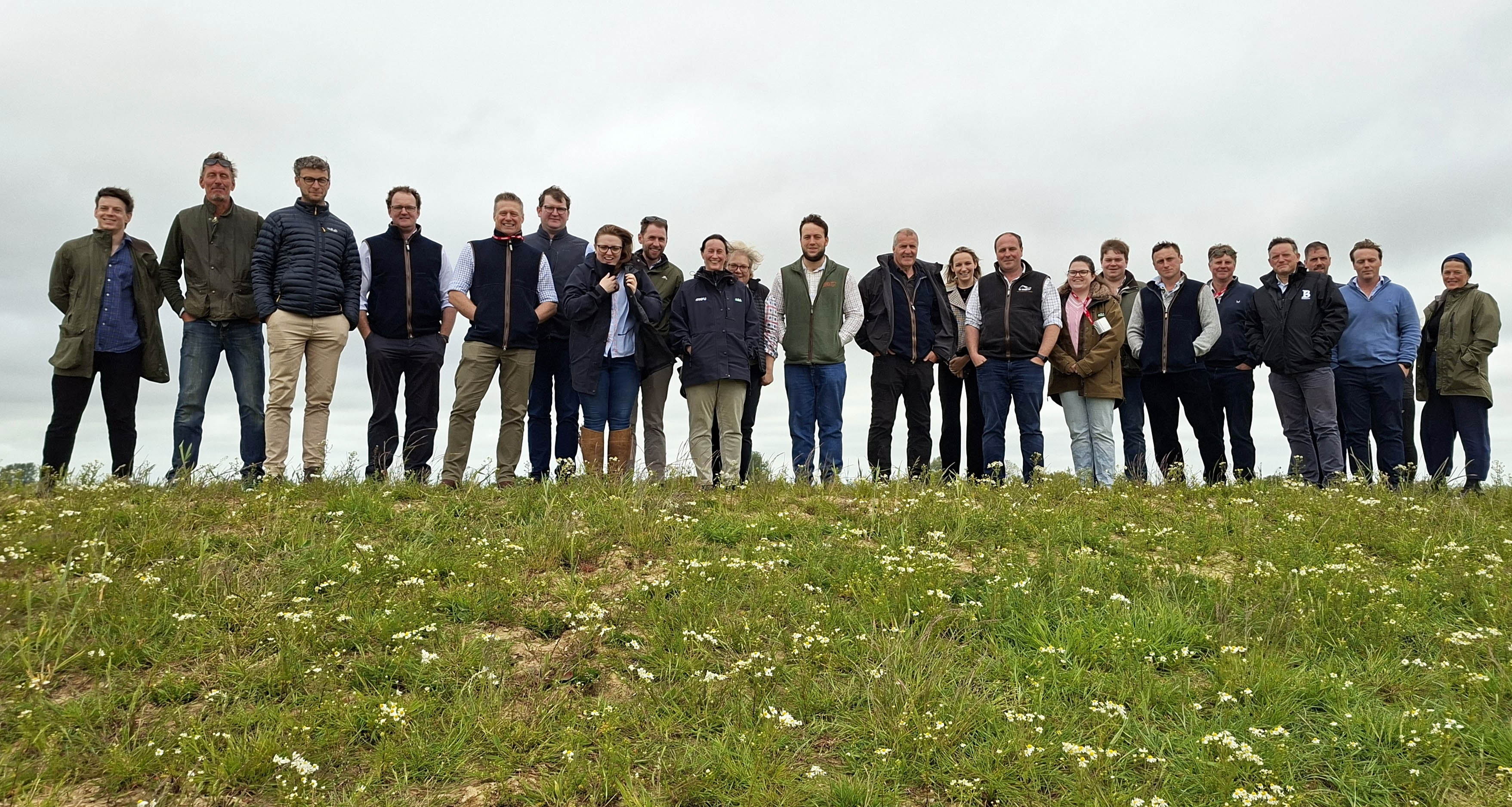 A group of farmers standing on a hill